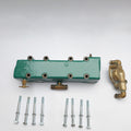 Green metal valve body with brass fitting and screws on a white background