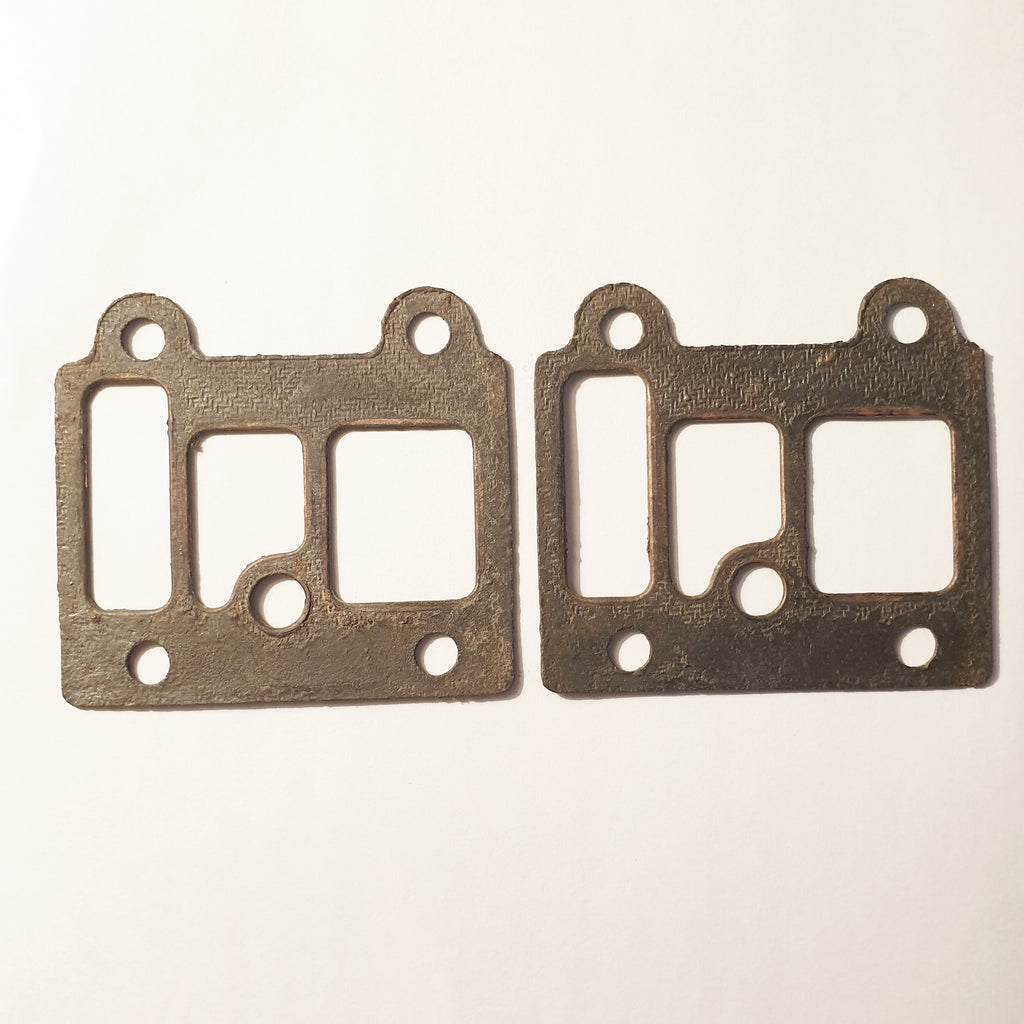 Two metallic gaskets on a beige background
